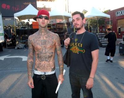 Shirtless Travis Barker shows off his tattoos while pal DJ AM sports a Gucci 