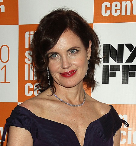 Elizabeth McGovern's short black hair is complemented by her dark purple