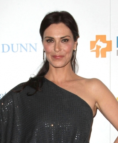 Michelle Forbes wears her long black hair pulled back