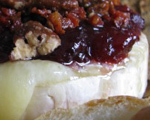 Baked Brie with Cranberry Sauce, Pancetta, and Spiced Pecans