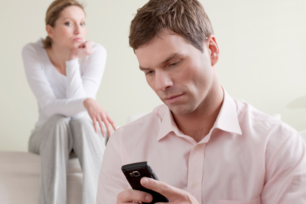 Jealous woman listening on husband's phone converstaion