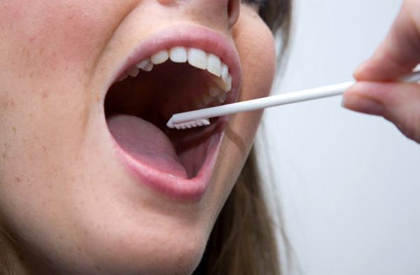 Woman getting mouth swabbed