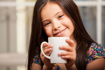 Little girl drinking coffee | Sheknows.com